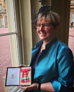 Board Member Sharon Blackburn proudly shows her CBE